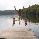 Father and His Sons Jumping into Lake